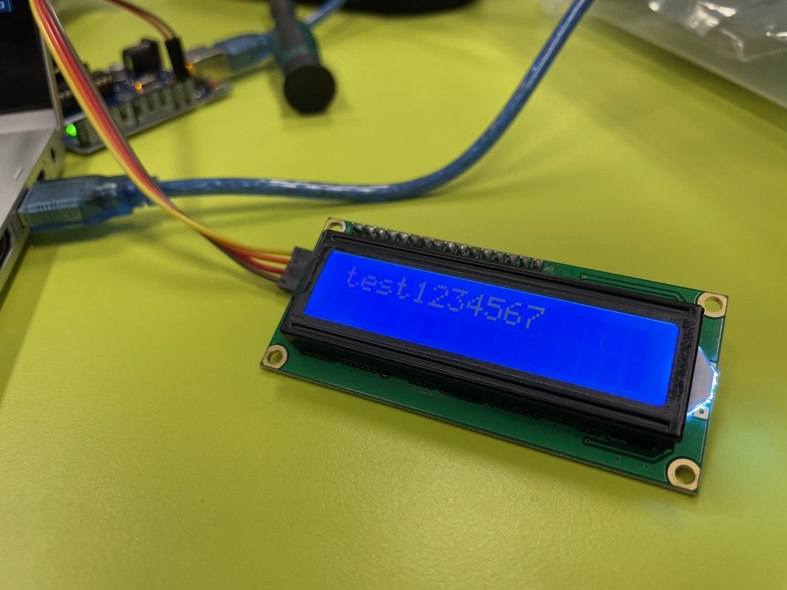 Blaues LCD-Display mit dem Text „Test1234567“, verbunden mit einem Arduino